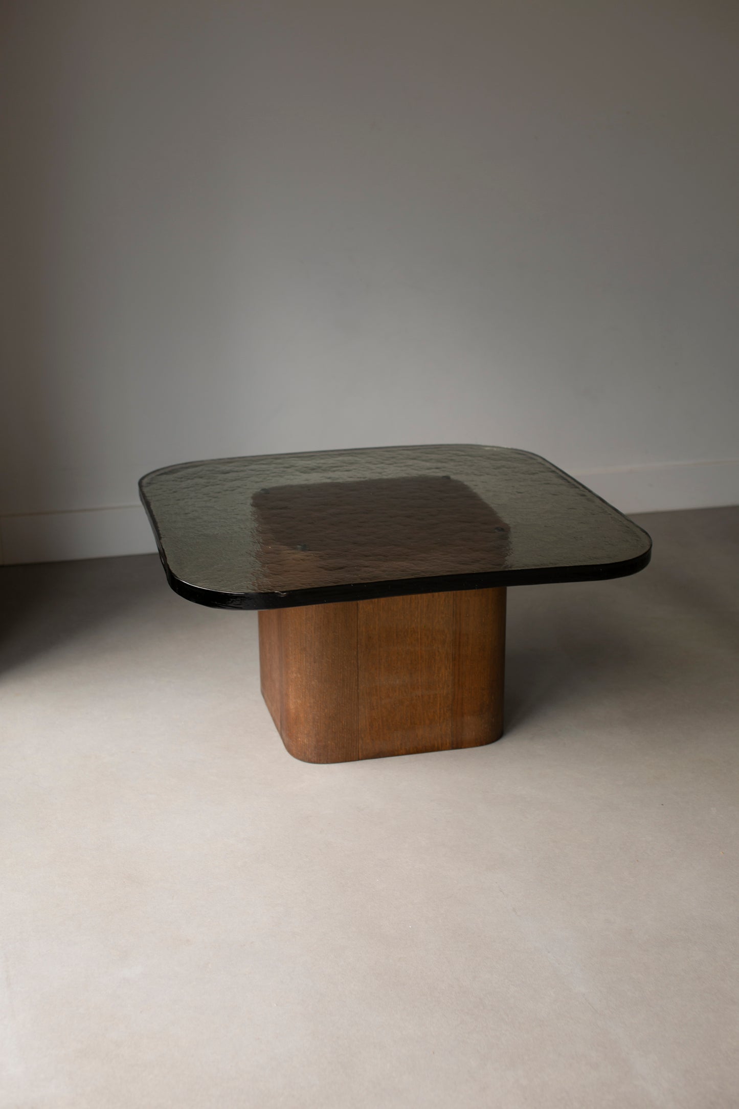 Heavy glass table on wooden pedestal