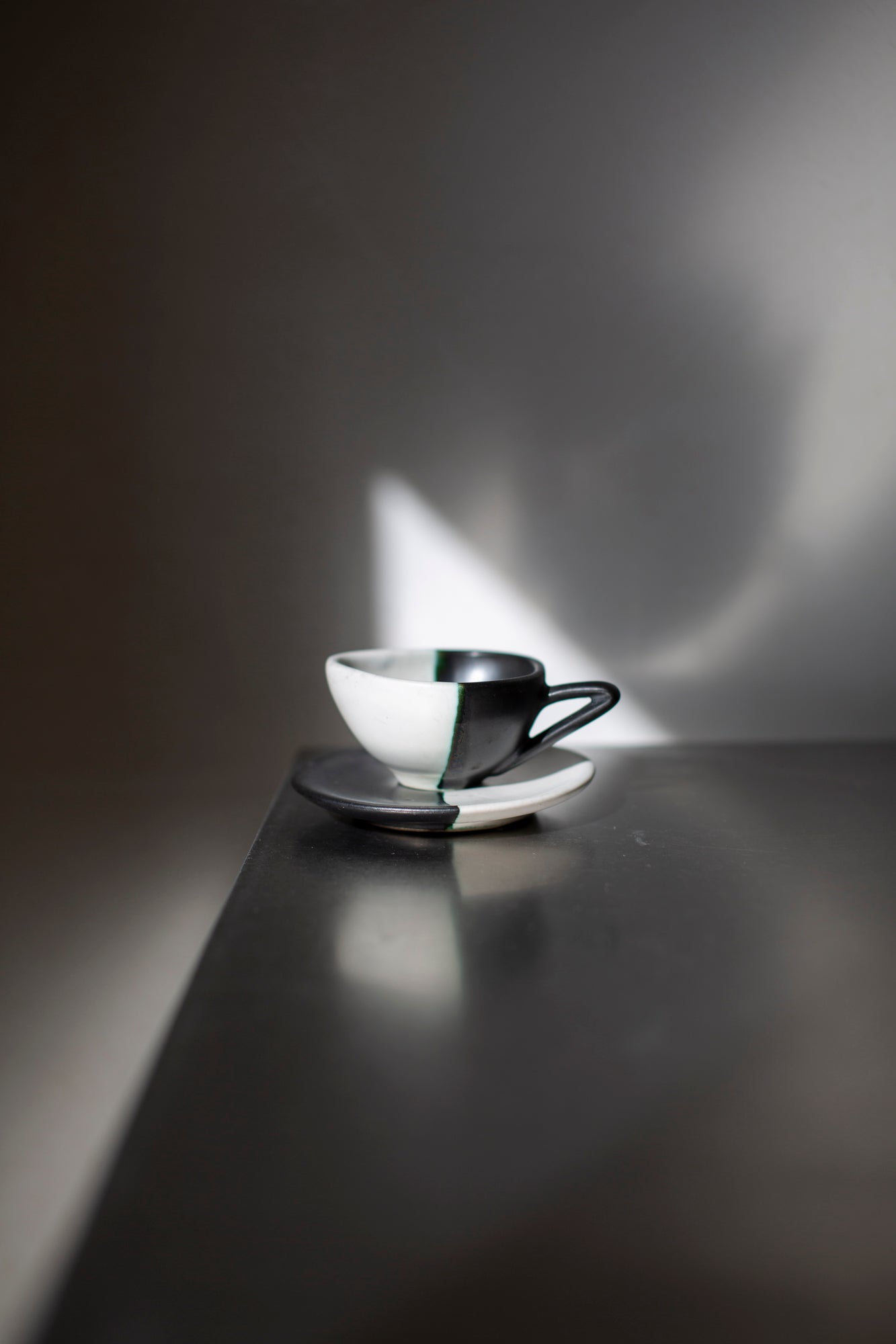Sculptural black & white ceramic espresso cup