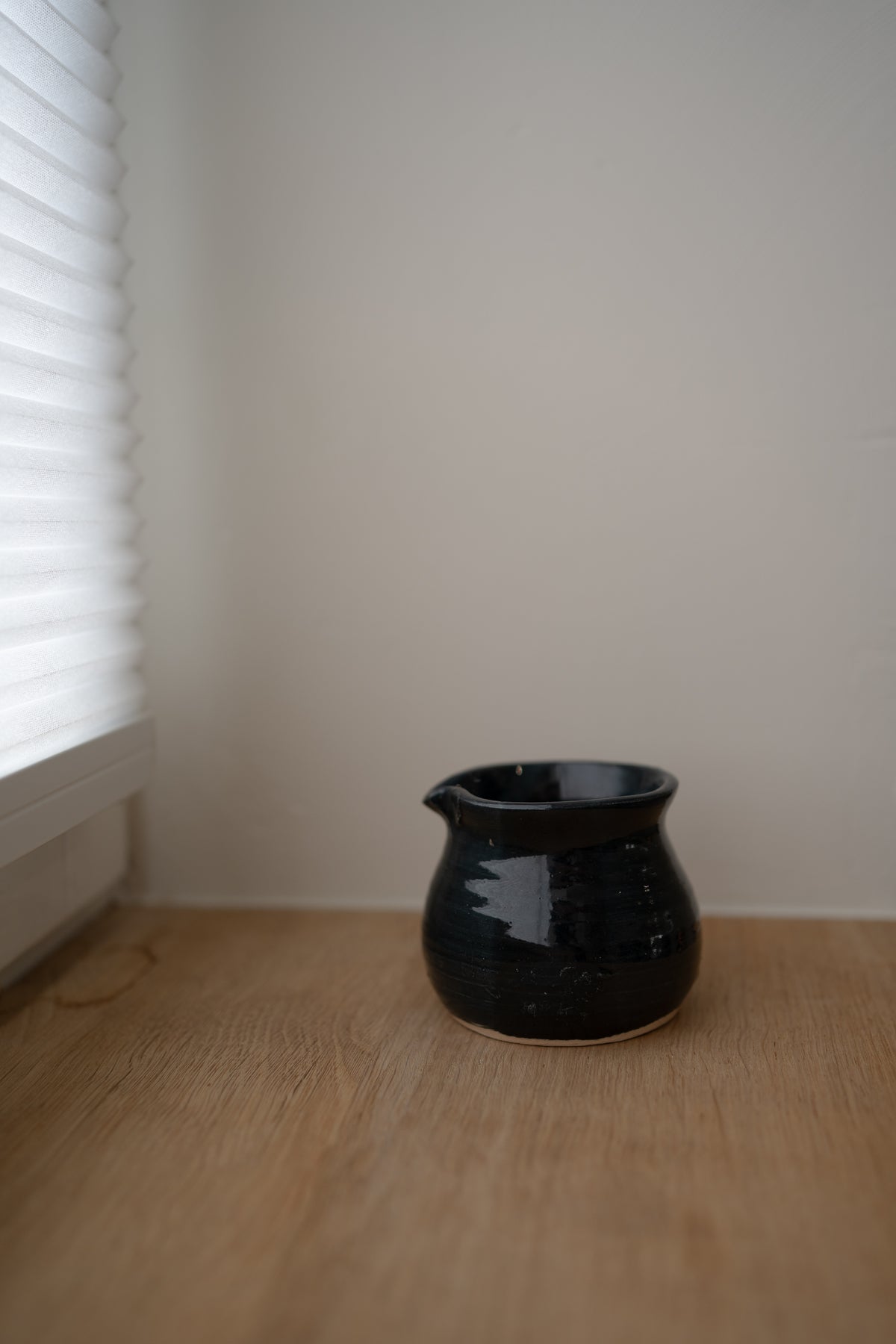 Handcrafted dark blue glazed ceramic creamer