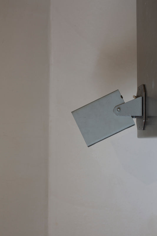 Artisanal minimalistic steel wall lamp