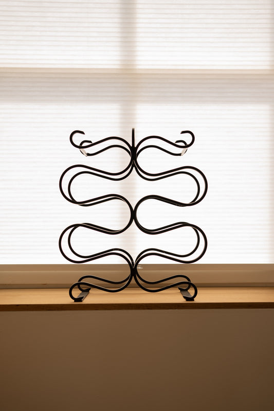 Vintage sculptural iron wine rack