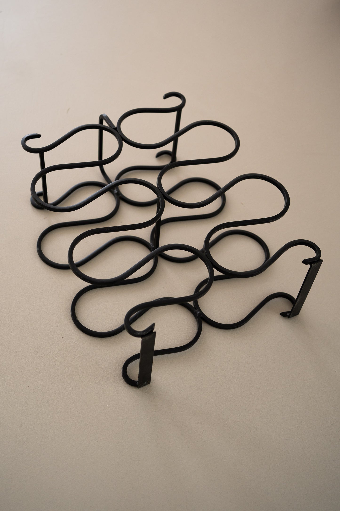 Vintage sculptural iron wine rack