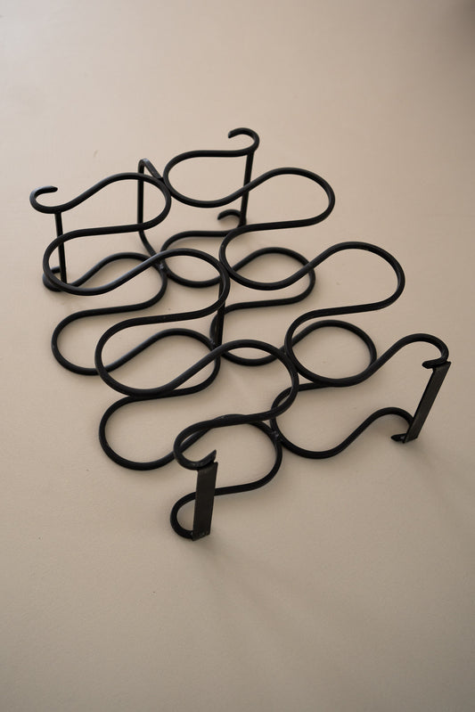 Vintage sculptural iron wine rack